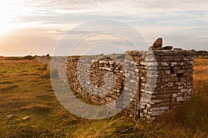 High stone wall in sunset