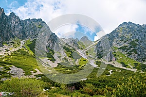 High Tatra mountains peak with the blue sky and clouds on the background in Slovakia. Tourist trails for hiking in