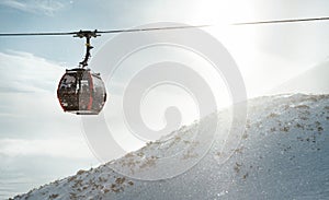 High Tatras cabine gondola rope way carrying a skiers to the mountain top. Active winter skiing and snowboarding concept image photo