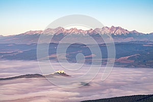 High Tatras mountain range and Spis castle at sunrise, Slovakia