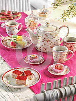 High tea birthday party table setting with food