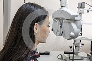 High technology concept health for eyes care - The optician ophthalmology doctor optometrist in the eyes clinic using a binocular
