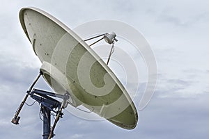 High technology and modern satellite dish on cloudy sky day background