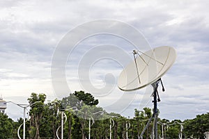 High technology satellite dish on cloudy sky day background with copy space