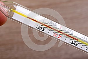 High temperature is first sign of corona virus infection or covid-19. Spirit or mercury thermometer with a high temperature