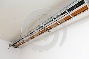 High tension cables in a support attached to the ceiling