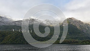 High tension power lines running across the mountain at Lake Manapouri in New Zealand