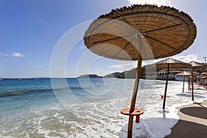 High tide on beach with manipulated parasol