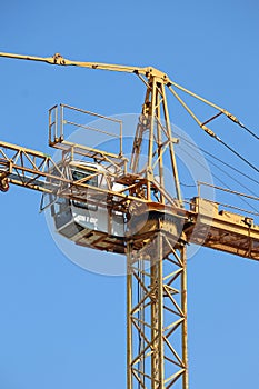 High tower crane against blue sky