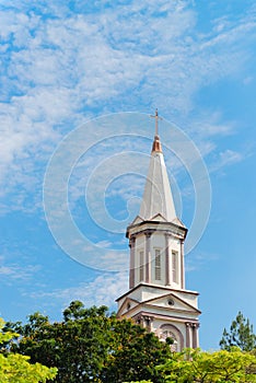 High tower turret of the church under blue sky