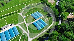 High tunnel greenhouse on large grassy vacant land near entrance of commercial farm in Ozarks aera, Mansfield, Missouri photo