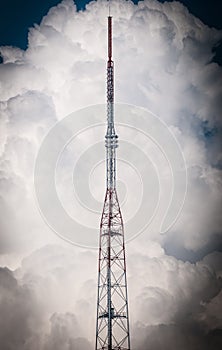 High TV tower and sky with clouds in background.