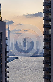 high view of Dubai Downtown cityline with Dubai Creek Canal at sunset time