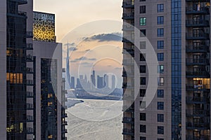 high view of Dubai Downtown cityline with Dubai Creek Canal at sunset time