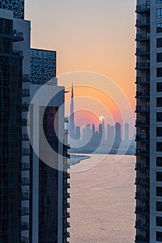 high view of Dubai Downtown cityline with Dubai Creek Canal at sunset time