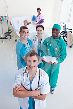 High view of medical team with a child in bed