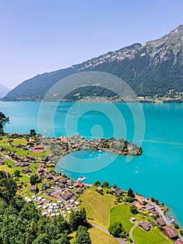 High view over the village of Iseltwald at the turquoise Brienz Lake