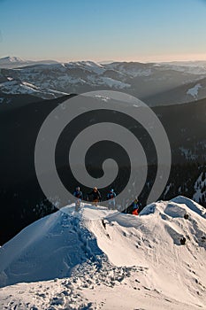 high view on ski tour tourist group at snowy mountain range against backdrop of magnificent landscape. Ski touring and