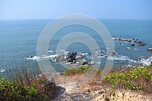 High view skyline beautiful deep blue sea landscape background with endless horizon at goa beach, India, rocky coast and