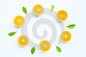 High vitamin C, Juicy and sweet. The round frame made of fresh orange fruit with leaves on white background