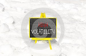 High volatility symbol. Concept words High volatility on beautiful black chalk blackboard. Chalkboard. Beautiful snow background.