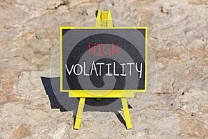 High volatility symbol. Concept words High volatility on beautiful black chalk blackboard. Chalkboard. Beautiful stone background