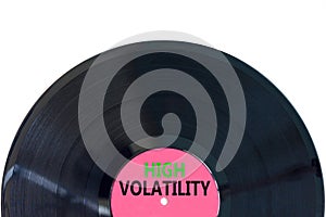 High volatility symbol. Concept words High volatility on beautiful black vinyl disk. Beautiful white table white background.