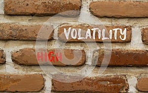 High volatility symbol. Concept words High volatility on beautiful brick wall. Beautiful red brown brick wall background. Business