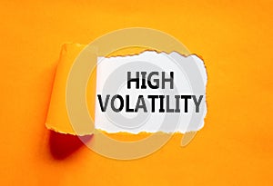 High volatility symbol. Concept words High volatility on beautiful white paper. Beautiful orange paper background. Business high