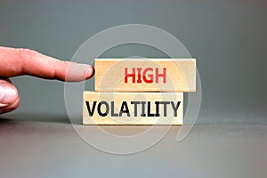 High volatility symbol. Concept words High volatility on beautiful wooden blocks. Beautiful grey table grey background.