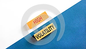 High volatility symbol. Concept words High volatility on beautiful wooden blocks. Beautiful white and blue background. Business