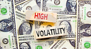 High volatility symbol. Concept words High volatility on beautiful wooden blocks. Dollar bills. Beautiful background from dollar