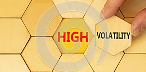 High volatility symbol. Concept words High volatility on beautiful wooden puzzles. Beautiful yellow paper background. Businessman