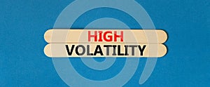 High volatility symbol. Concept words High volatility on beautiful wooden stick. Beautiful blue table blue background. Business