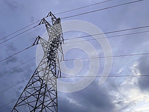High voltage cable tower with cloudy sky
