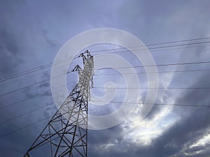 High voltage cable tower with cloudy sky