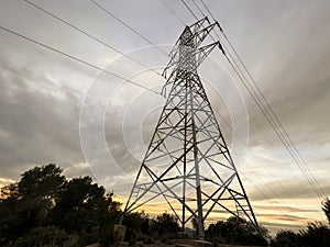 High voltage cable tower with cloudy sky