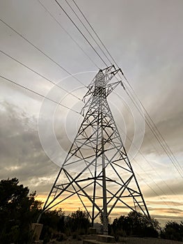 High voltage cable tower with cloudy sky