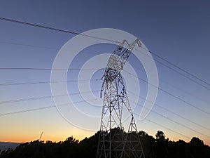 High voltage cable tower during sunset