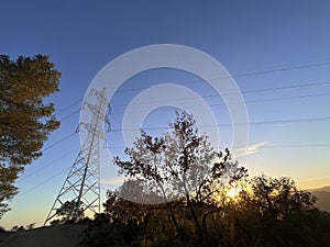 High voltage cable tower during sunset