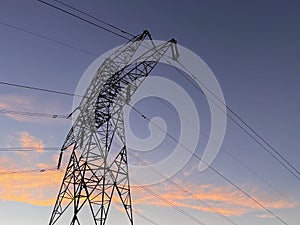 High voltage cable tower during sunset