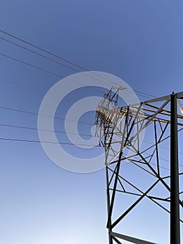 High voltage cable tower during sunset on a mountain