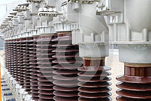 High voltage ceramic isolators arranged in a row