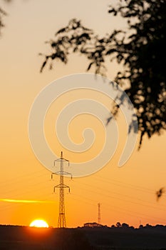 high voltage column in sunset