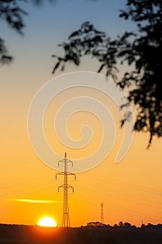 high voltage column in sunset