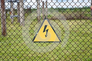 High voltage danger sign on a fence