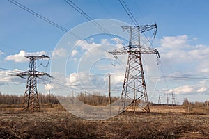 High-voltage electric main against the dark blue sky