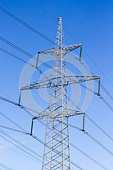 High-voltage electric main against the dark blue sky
