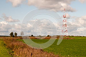 High-voltage electric main against the dark blue sky in summer day