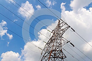 High-voltage electric main against the dark blue sky in summer day